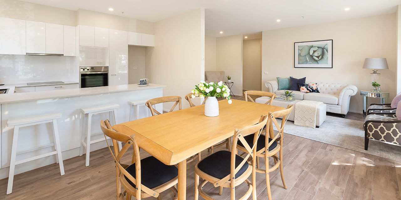 View of the dining room and kitchen in an apartment at Karana Retirement living - boutique aged care in Kew Melbourne