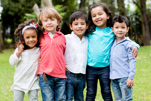Five children smiling in park
