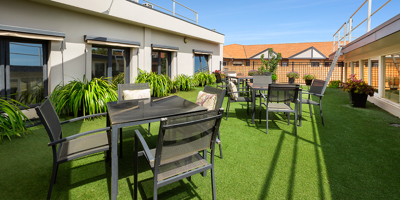 Roof-top terrace area with seating and tables at Karana Retirement Community, Baptcare. Boutique aged care in Kew, Melbourne.